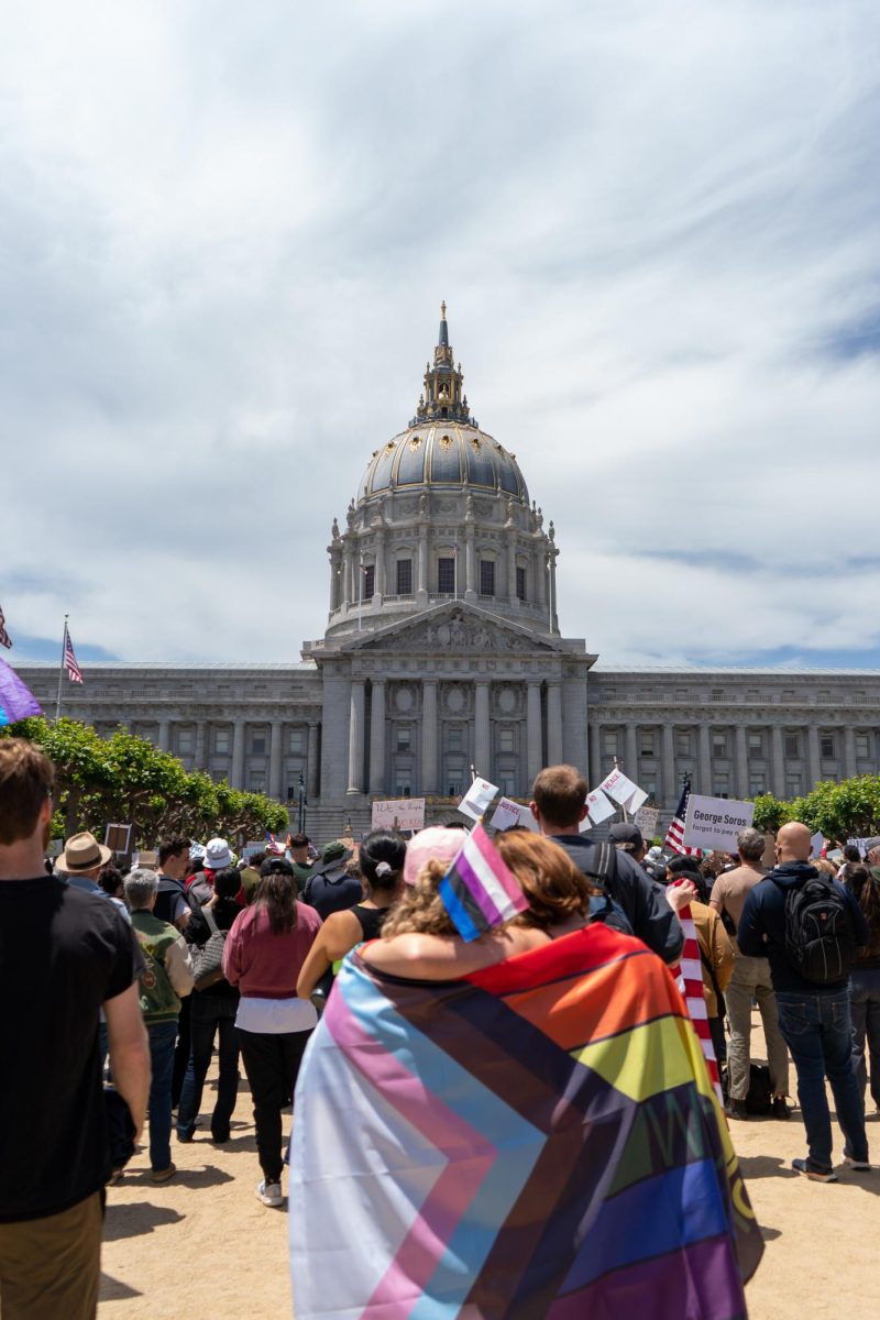 Two protestors hold each other while listening to a speaker at "No Kings Day" on Saturday, June 14, 2025 in San Francisco.