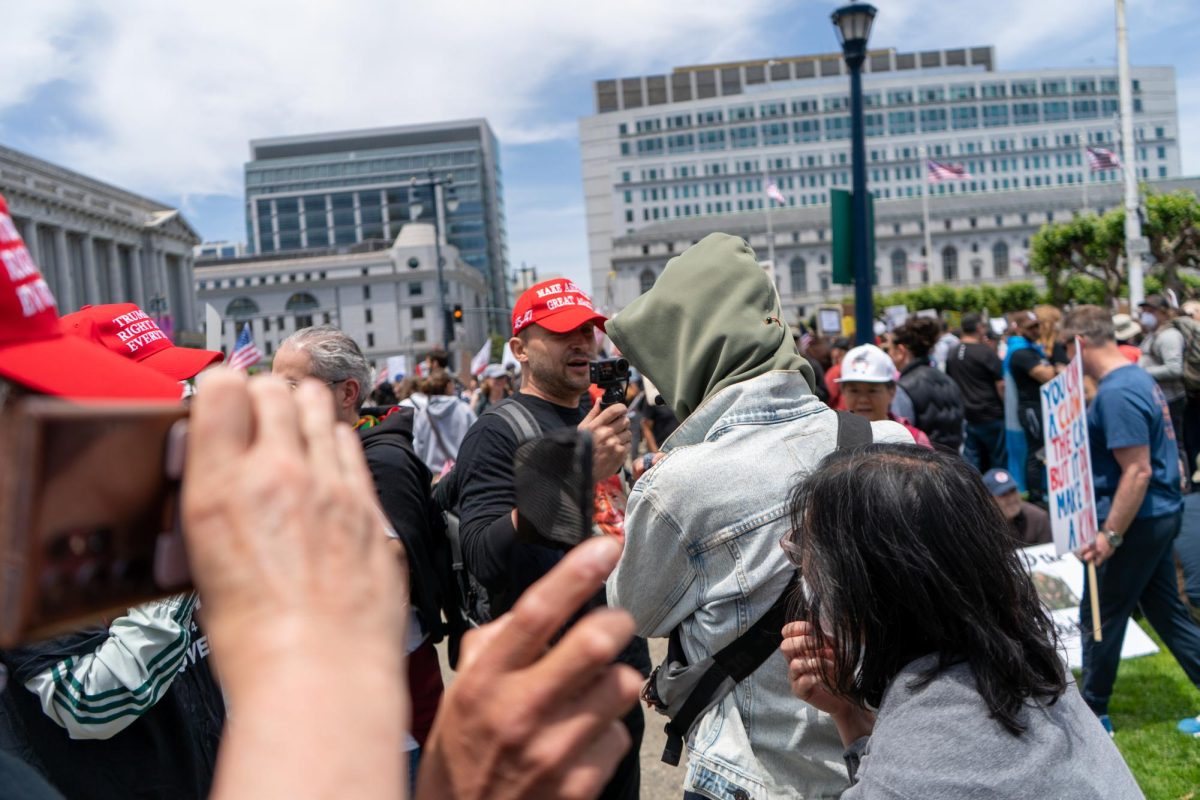 Three supporters of the current president antagonize peaceful protestors on "No Kings Day" at Civic Center plaza on Saturday, June 14, 2025 in San Francisco.