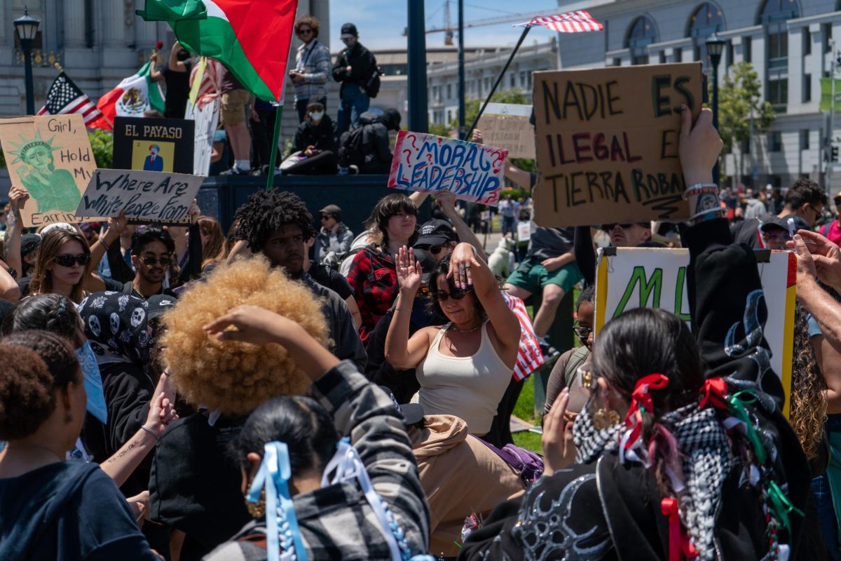 Protestors sing and dance at Civic Center Plaza for "No Kings Day" on Saturday, June 14, 2025 in San Francisco.