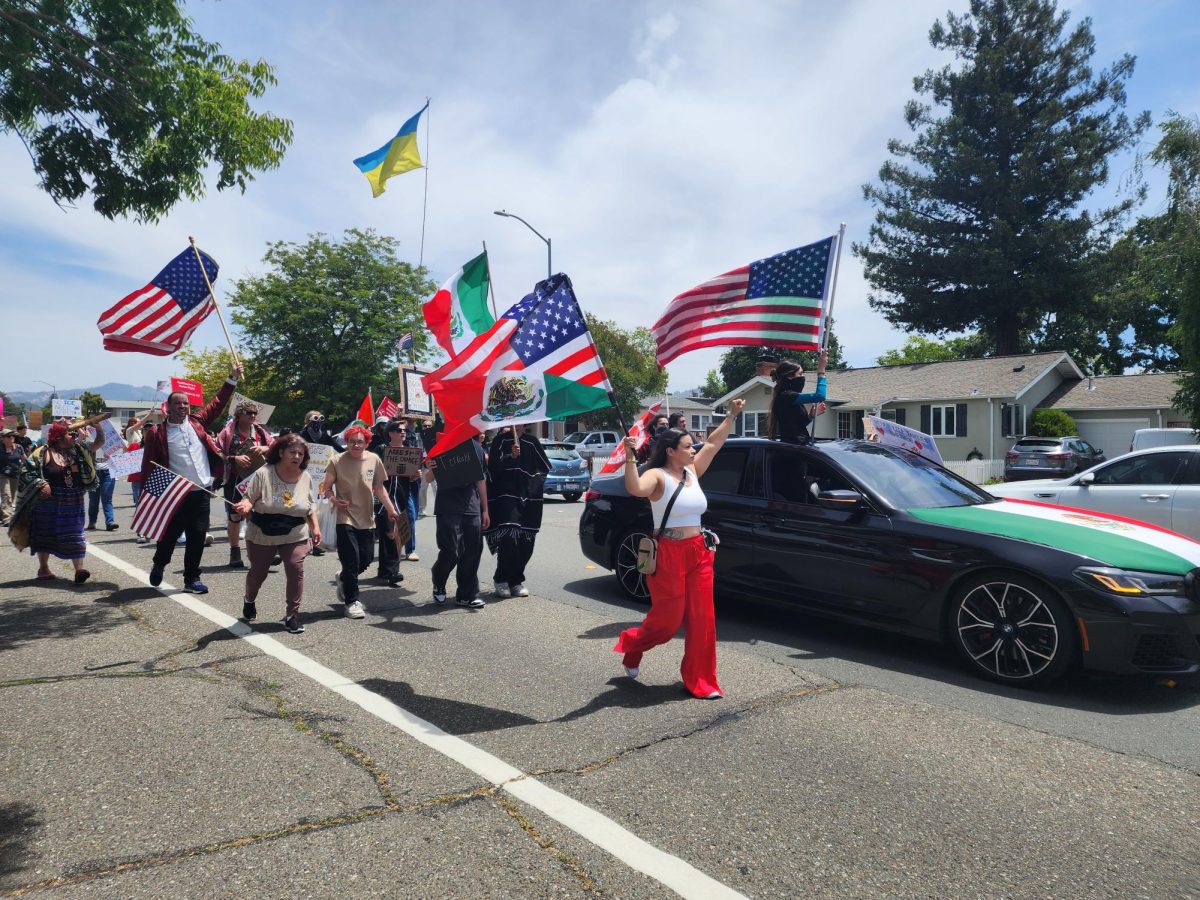 Protestors march down Farmers Lane towards Hoen Avenue on June 14  to share their disdain for the Trump administration and the president's apparent over-reach of influence in the government.