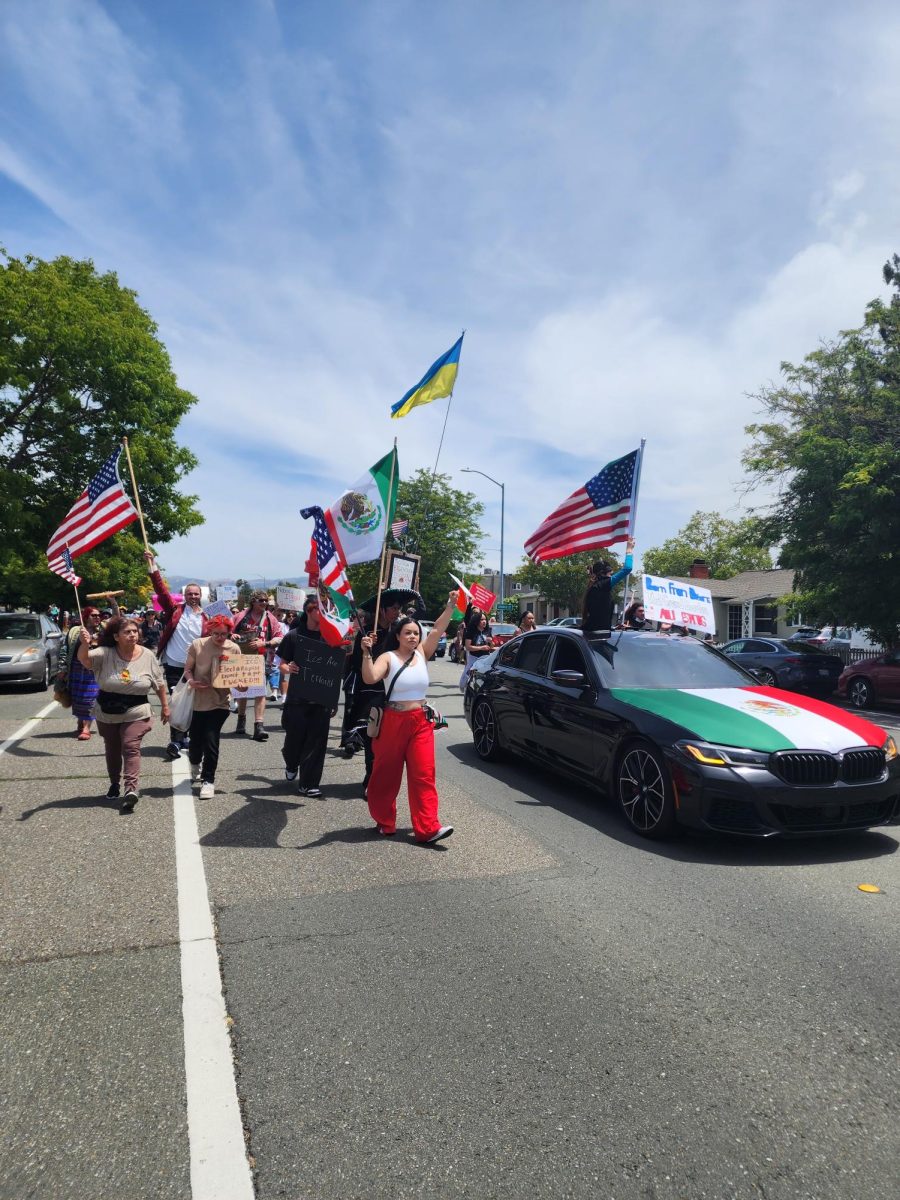 Protestors march along Sonoma Avenue towards Doyle Park Drive in the last stretch of the demonstration against Donald Trump’s administration.