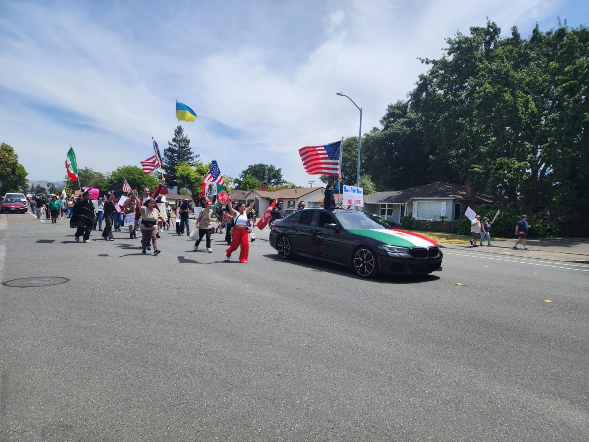 Protestors march along Sonoma Avenue towards Doyle Park Drive in the last stretch of the demonstration against Donald Trump’s administration.