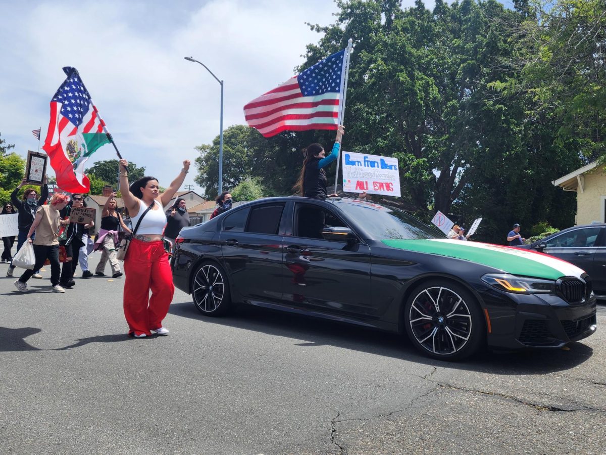 Protestors march along Sonoma Avenue towards Doyle Park Drive in the last stretch of the demonstration against Donald Trump’s administration.