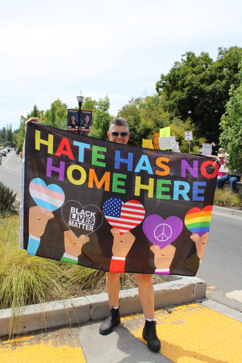 Local protestor, S’na, shows off their flag in the middle of the street during the No Kings Protest in downtown Healdsburg, Saturday, June 14. 