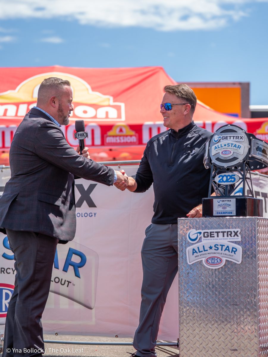 Announcer Brian Lohnes welcomes NHRA president Glen Cromwell to the stage during the GETTRX All Start Pro Stock Motorcycle Callout at the DENSO NHRA Sonoma Nationals on Friday, July 25, 2025 in Sonoma.