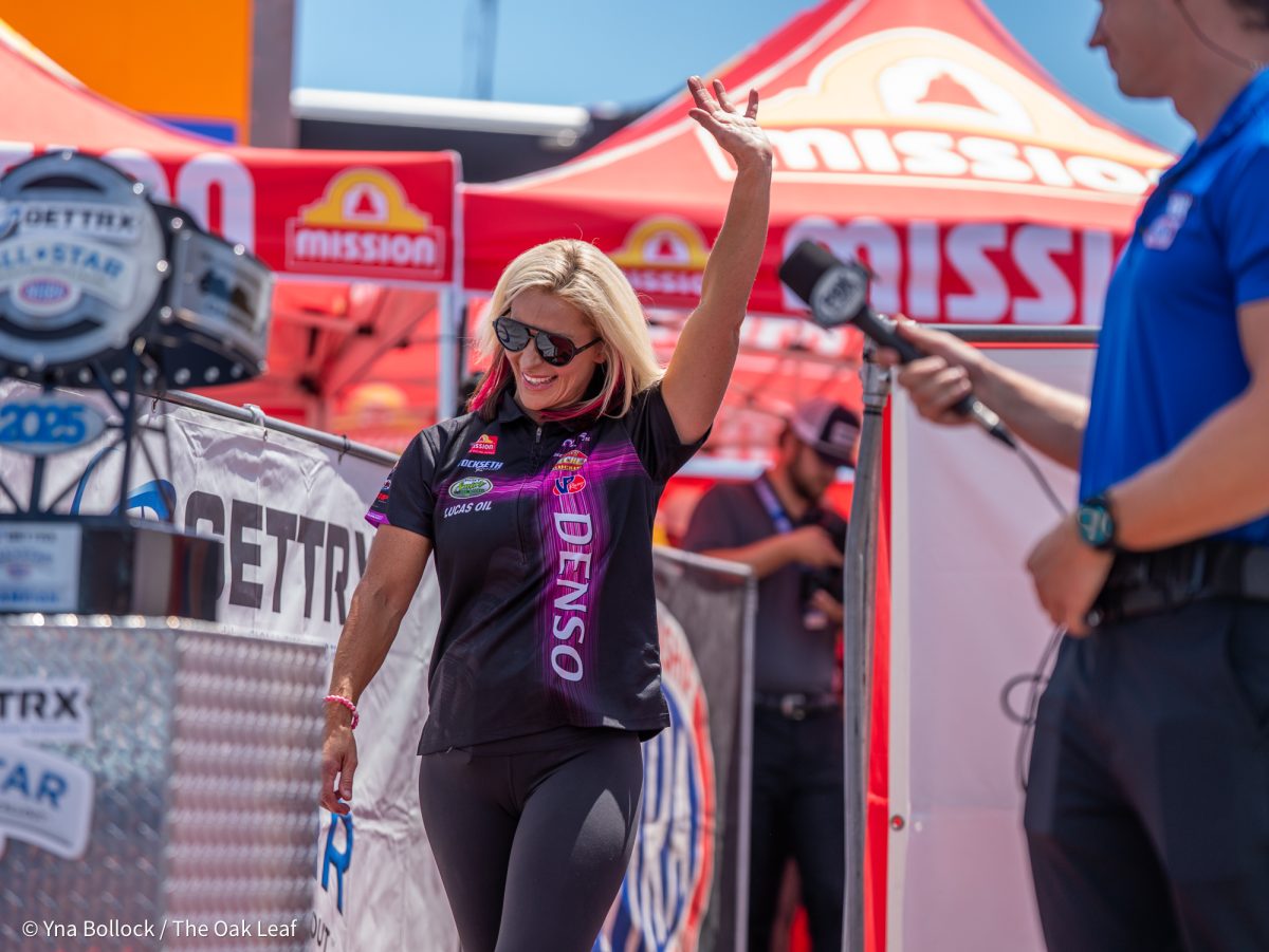 Pro Stock Motorcycle driver Angie Smith waves to the crowd as she walks out for the GETTRX All Start Pro Stock Motorcycle Callout at the DENSO NHRA Sonoma Nationals on Friday, July 25, 2025 in Sonoma.