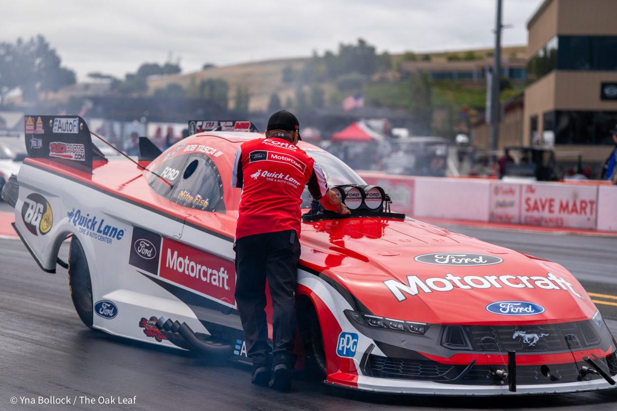 Funny Car driver Bob Tasca III gets ready to race in Q3 with a member of his crew on day two of the DENSO NHRA Sonoma Nationals on Saturday, July 26, 2025 in Sonoma. 