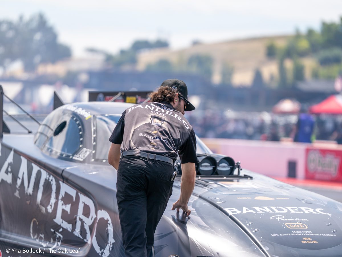 Funny Car driver Alexis DeJoria rolls down the drag strip towards a member of her crew to prepare for her Q3 run on day two of the DENSO NHRA Sonoma Nationals on Saturday, July 26, 2025 in Sonoma.