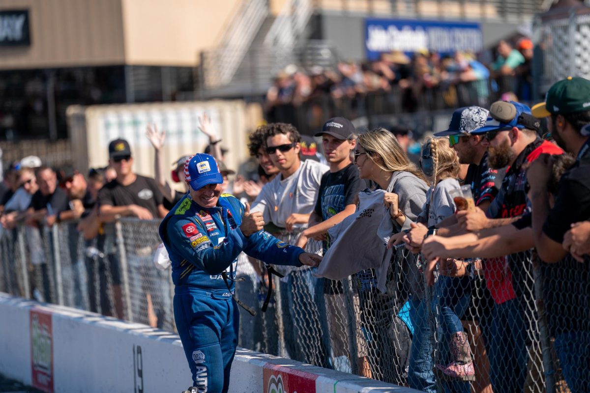 Funny Car driver Ron Capps gives t-shirts away to fans before this fourth qualifying run at the DENSO NHRA Sonoma Nationals on Saturday, July 26, 2025 in Sonoma.