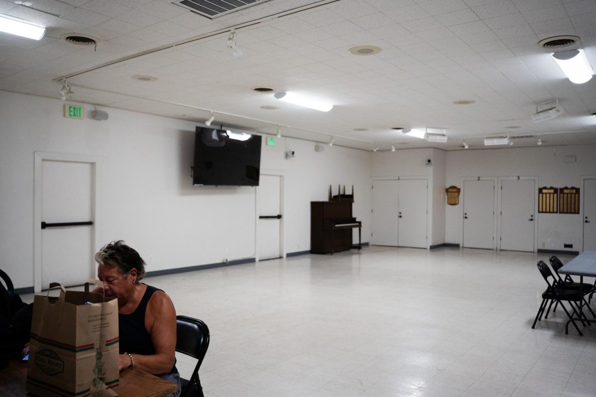 Jon Dell practices his drawing skills at the Calistoga Community Center, which was designated as an evacuation shelter but sits mostly empty, at 6:42 p.m. on Thursday, Aug. 21, 2025. Dell supervised the community center and mentioned only seeing roughly six people that day. "This is like business as usual, you know, no one seems panicked," Dell said.