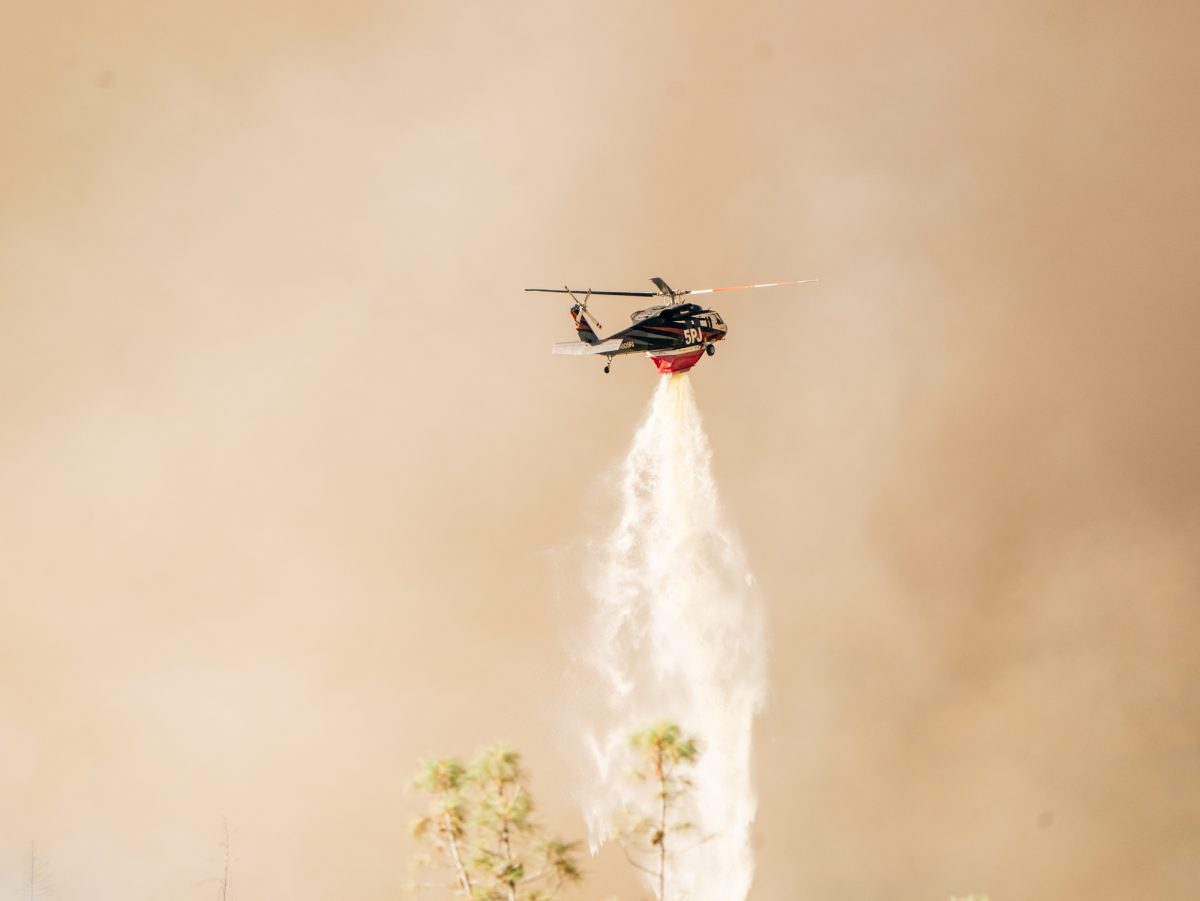 A Cal Fire contract helicopter, 5PJ releases water upon the Pickett Fire near Calistoga on Thursday, Aug. 21, 2025.