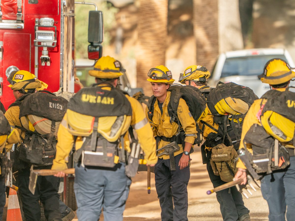 Cal Fire's wildland crew prepare to hike up to active zones of the Pickett Fire from their base camp on Pickett Road. As of 7 p.m., temperatures still lingered in the high 90s in Calistoga on Thursday, Aug. 21, 2025.