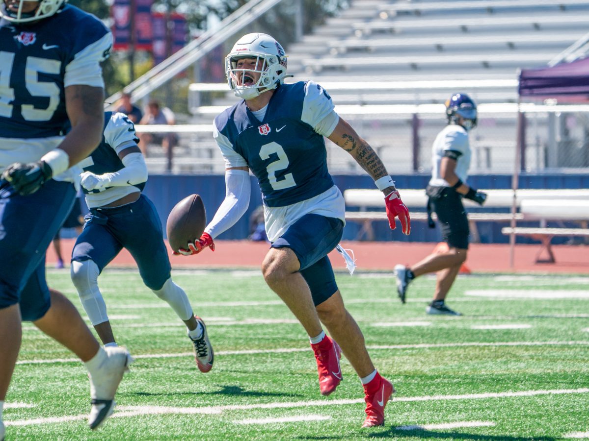 Bear Cubs defensive back Dante Antonini runs towards the home team to celebrate after intercepting the opening drive on the Jaguar 35-yard line in the first quarter against San Jose City College on Saturday, Sept. 20 at home.