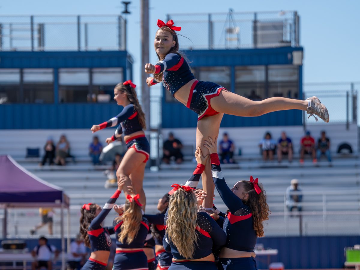 Bear Cubs cheerleader Hannah Nelson holds a one-legged extension flair during the cheer halftime performance on Saturday, Sept. 20 at home.