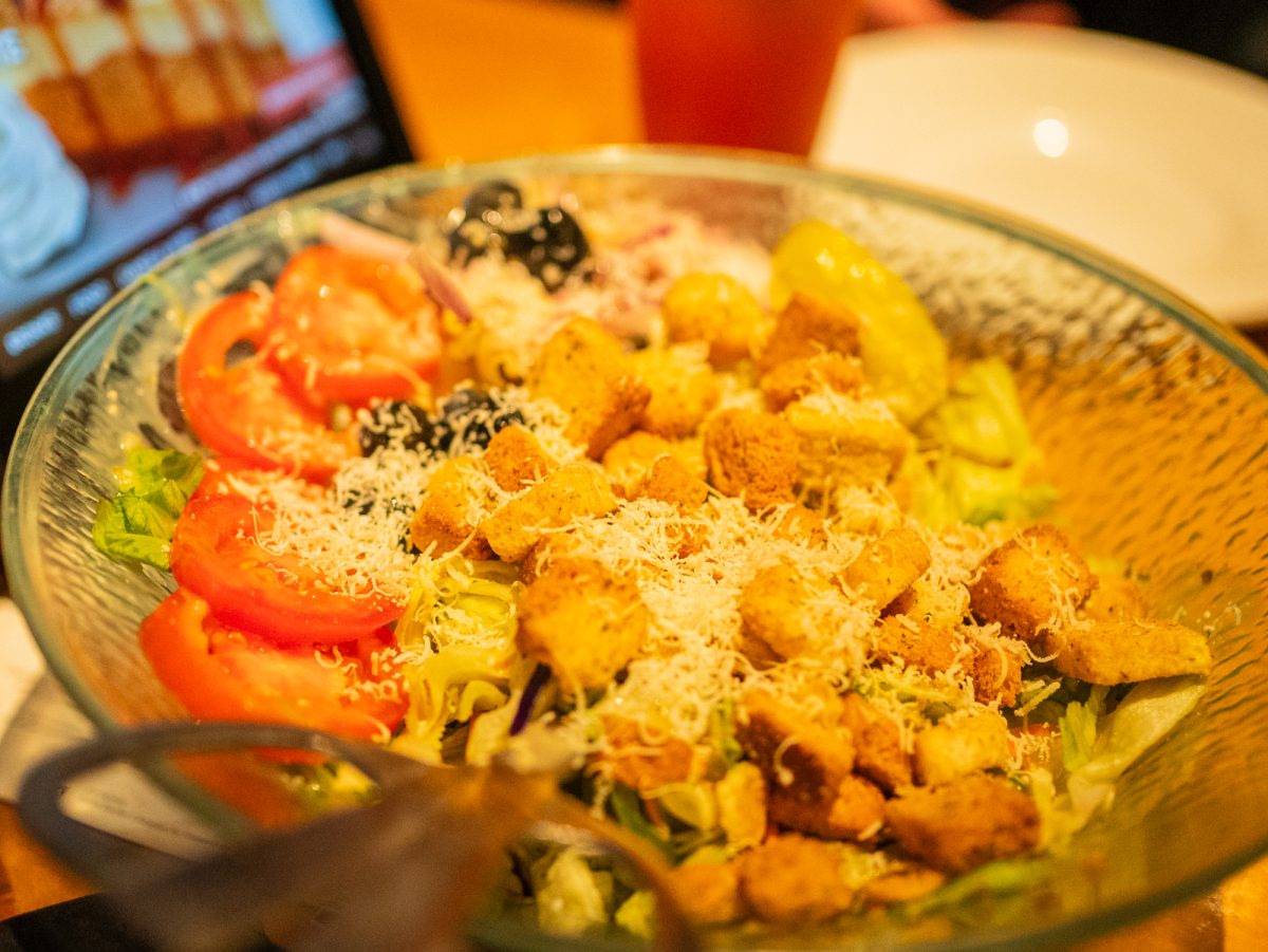 The house salad is made of iceberg lettuce with black olives, tomatoes, shredded carrots, pepperoncini peppers, croutons and Parmesan cheese in Sept. 2025.