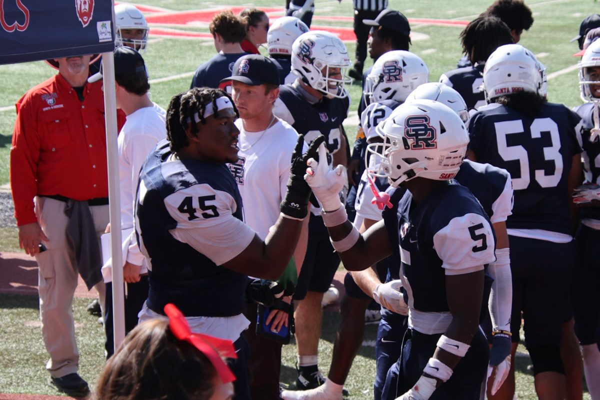 From left to right, defensive line Brandon Williams celebrates with defensive back Khai Dukes after a clutch play during the against Laney on Saturday, Sept. 27 at home.