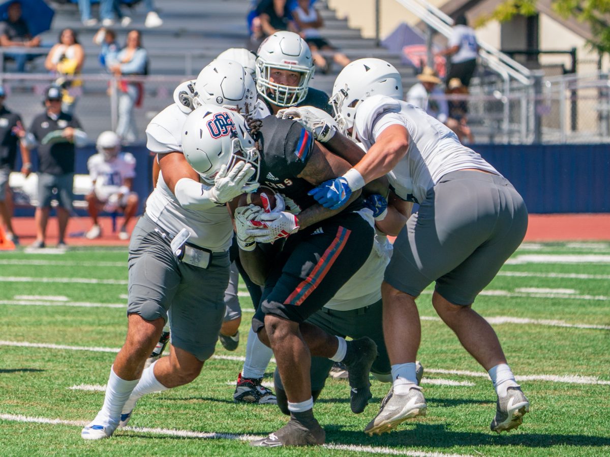 SRJC running back Zion Williams is swarmed by the Modesto defense in the first quarter against Modesto Junior College on Saturday, Sept. 6, 2025 in Santa Rosa.
