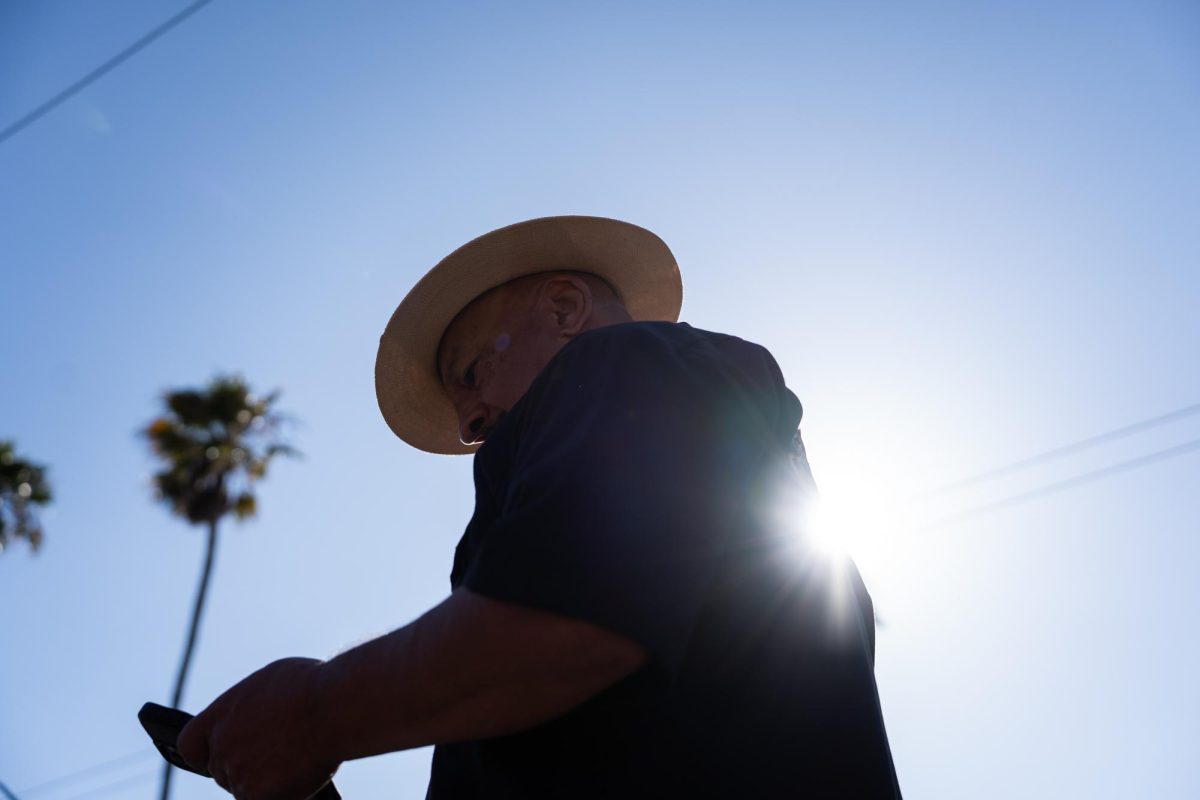 Chicano artist David Gonzales circles the hopping pit for the Thrill of the Hop contest during the King of the Streets lowrider parade on 24th and Mission Street in San Francisco on Saturday, Sept. 20, 2025.