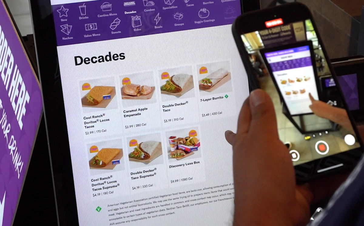 Johnny Oliver records an Instagram video while ordering a Cool Ranch® Doritos® Locos Tacos from the Y2K Decades Menu.