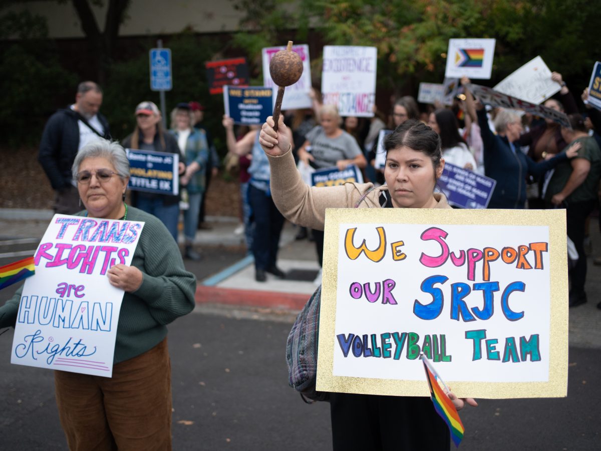 Supporters of a trans athlete's rights to participate on the SRJC women's volleyball team steps in front of the opposing demonstrators holding signs ahead of Wednesday night's matches against American River on Wednesday, Oct. 8.