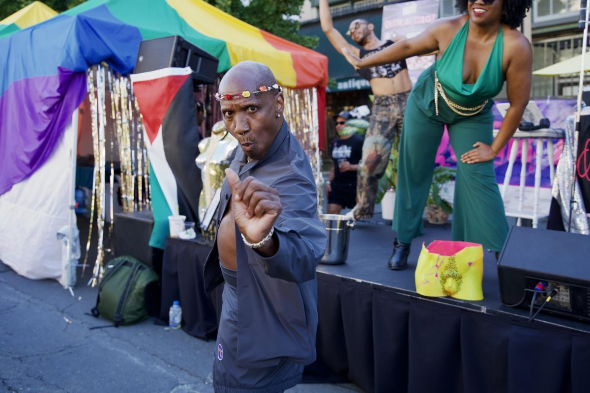 Cornelius Washington (left) strikes a pose while dancing with Jean Omen and G-Funk (right) at the Queer AF Stage at the Castro Street Fair on Sunday Oct. 5, 2025.   