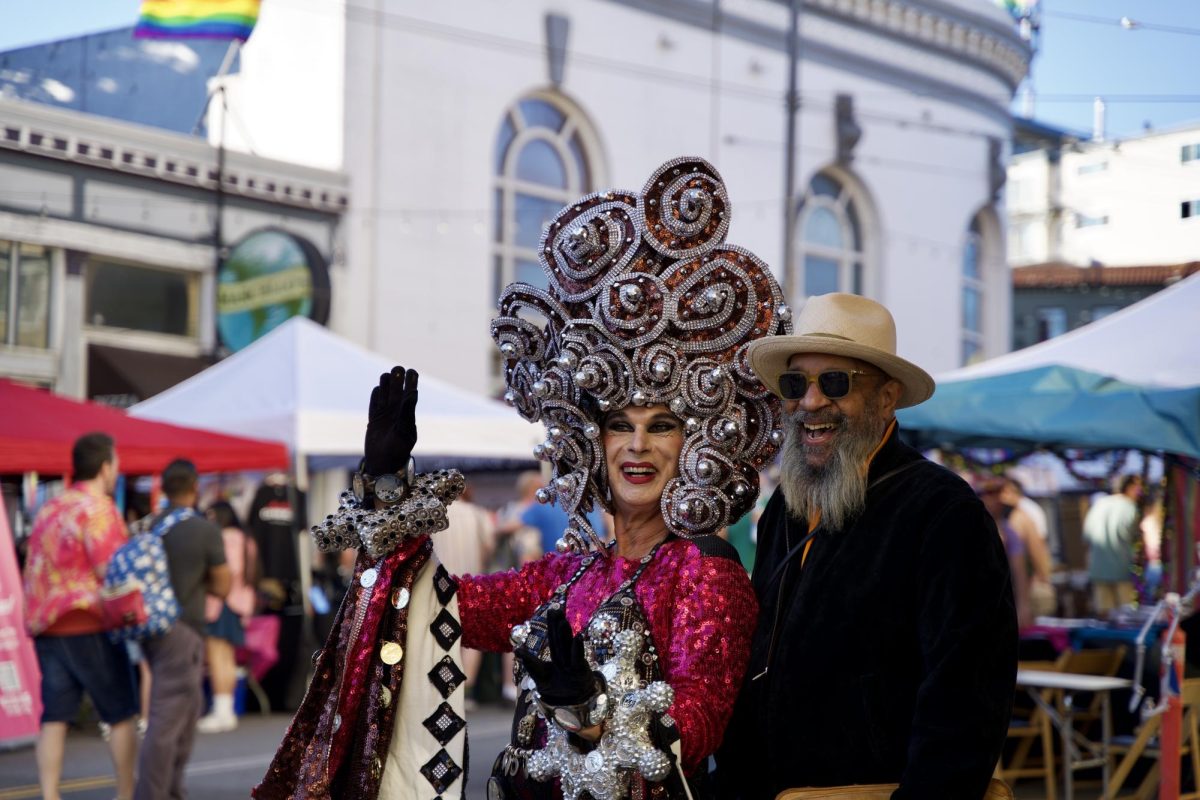 A drag artist and attendee share a laugh (and love for headwear) as they pose for a photo at the Castro Street Fair on Sunday Oct. 5, 2025. 