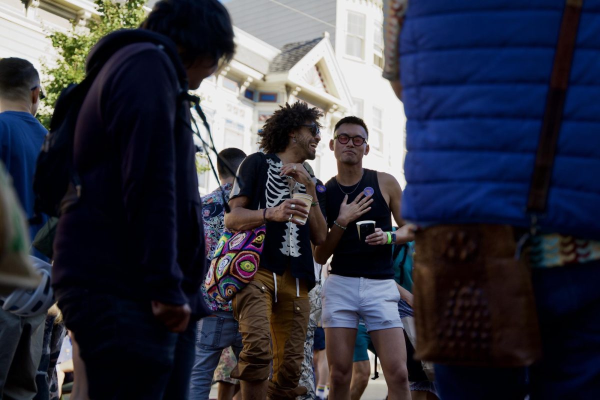 Amidst a crowd of dancers, two Castro Street Fair attendees share a heartfelt moment during an animated conversation on Sunday Oct. 5, 2025. 