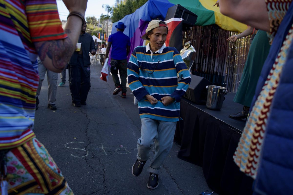 A Castro Street Fair attendee shares the Queer AF Stage with performers and dazzles the crowd with their dance moves on Sunday Oct. 5, 2025. 
