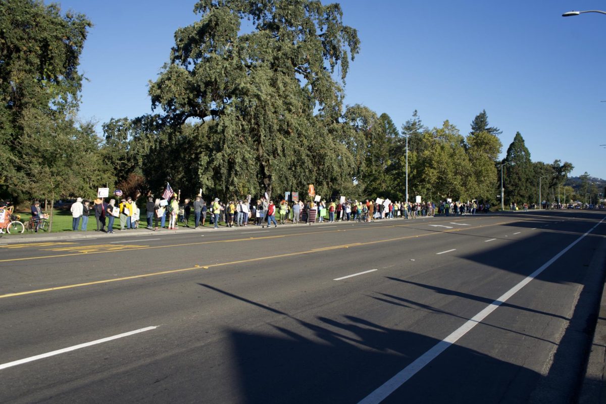 Community members gather on Mendocino Avenue to kick off a day of No Kings protests on Saturday Oct. 18. 