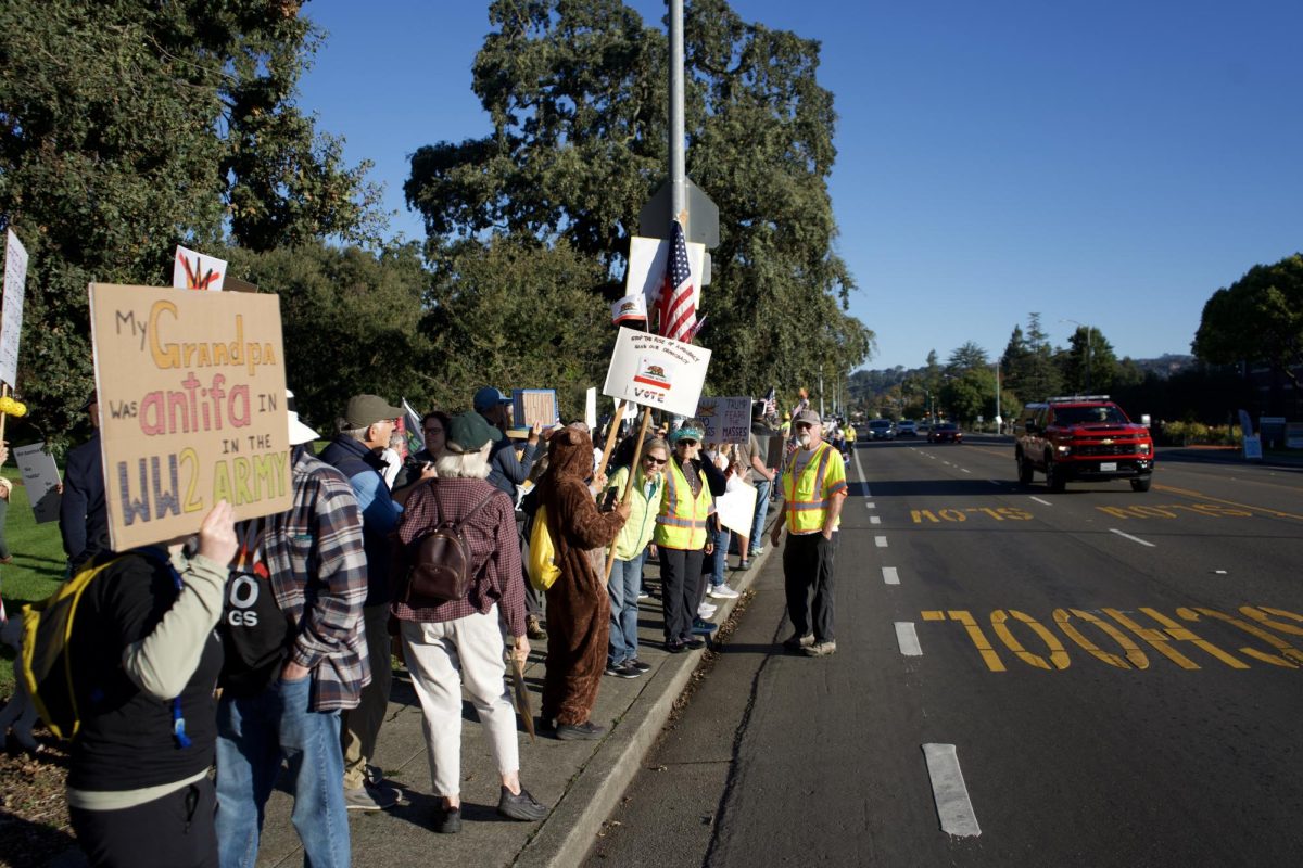 Community members gather on Mendocino Avenue to kick off a day of No Kings protests on Saturday Oct. 18. 