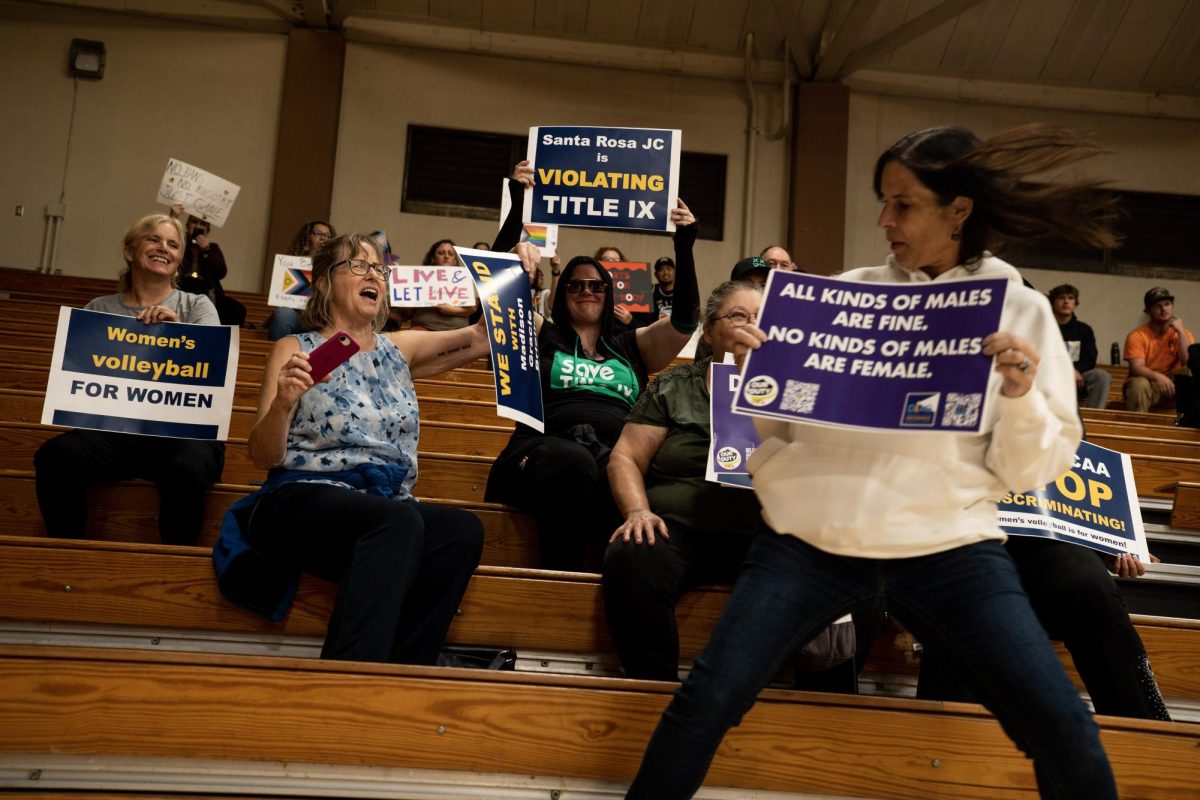 Erin Friday, president of Our Duty USA and attorney for a former women’s volleyball coach at San Jose State slides into frame for a picture during the SRJC women’s volleyball game Wednesday, Oct. 8 in Haehl Pavilion. 
