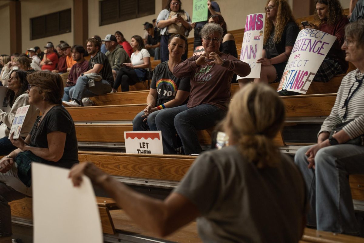 Trans allies smile and make a heart gesture toward Beth Bourne, Chair of Yolo County's chapter of Moms for Liberty, in response to her demonstrations against a trans athlete at the SRJC women’s volleyball game on Wednesday, Oct. 8 in Haehl Pavilion. 