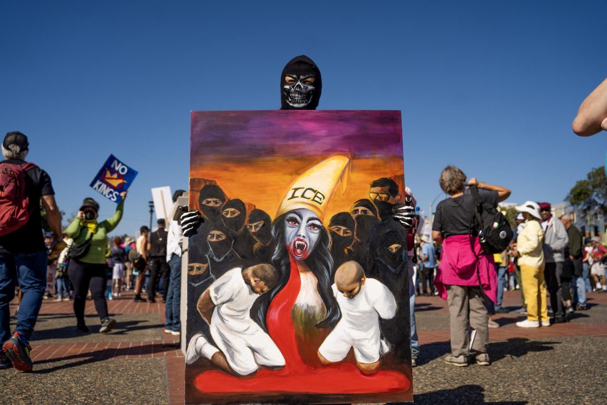 An artist portrays their representation of ICE deportations at a No Kings protest Saturday, Oct. 18, 2025 in Oakland, Calif. 