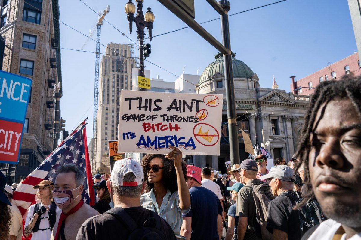 A demonstrator compares a popular HBO series, known for its medieval savagery, to the Trump administration at a No Kings protest Saturday, Oct. 18, 2025 in San Francisco, Calif.

