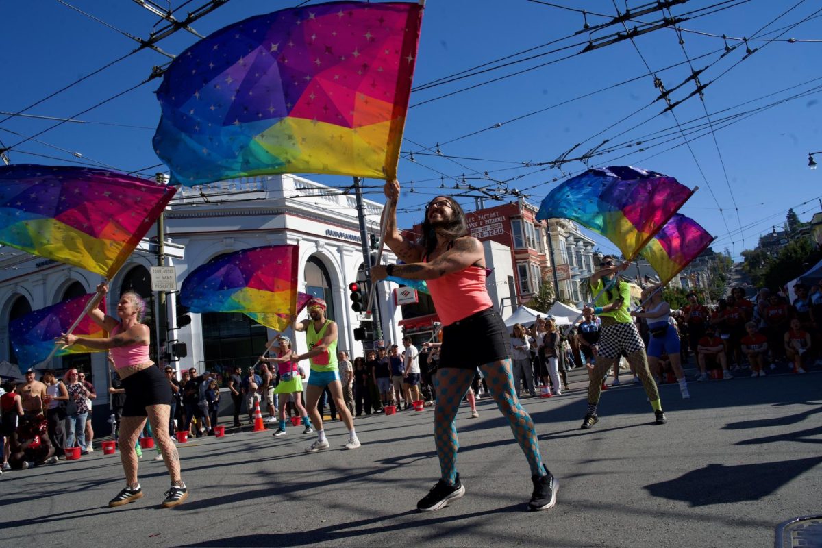 The Harvey Milk Pride Colorguard, a new San Francisco colorguard group, waves geometrical rainbow flags in unison during their performance at the Castro Street Fair on Sunday Oct. 5, 2025. 