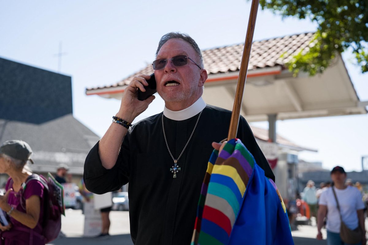 A clergy member joins the No Kings protest Saturday, Oct. 18, 2025 outside the Chinese Independent Baptist Church in Oakland, Calif.