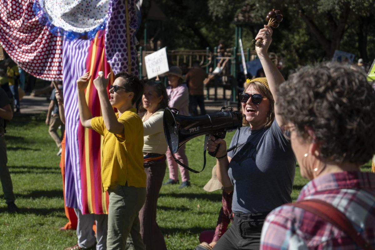 Protesters sing and dance at Doyle Park as, "an act of sovereignty and liberation" for No Kings day Oct. 18.