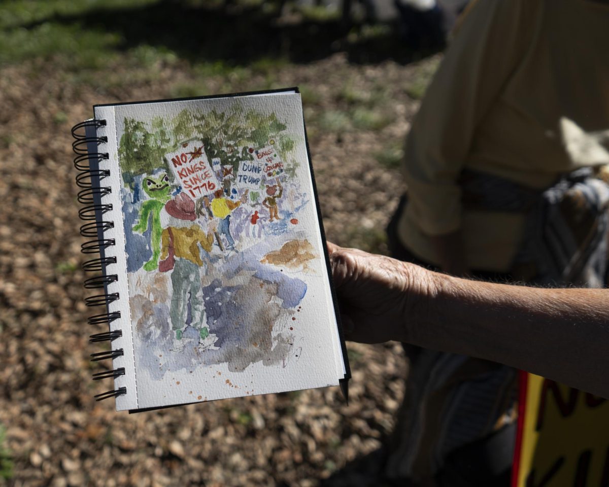 Protesters display their artwork for No Kings day Oct. 18.