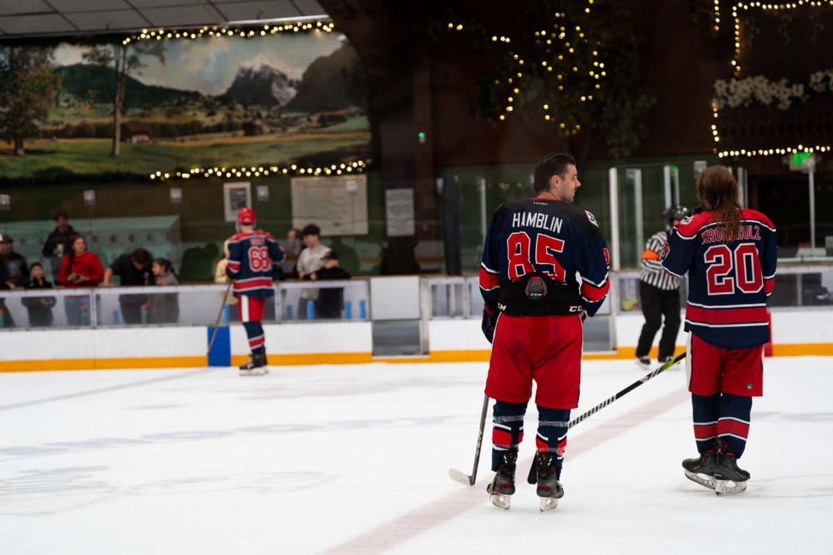 Polar Bears defense Owen Hamblin, left, and captain Kai Krombholz, right, sit back before the Chuck-A-Puck competition between periods during their match against Santa Clara University on Saturday, Oct. 4, 2025 at Snoopy's Home Ice.