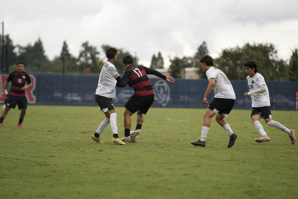 SRJC central midfielder Dominic Sanchez fends off San Joaquin defender while being surrounded at home Tuesday, Oct. 14.