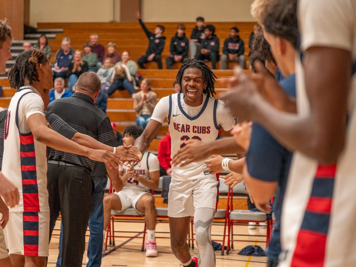 Bear Cub sophomore forward Travis Hightower high fives his way down the lineup during pre-game announcements against Napa Valley College on Tuesday, Nov. 11 at home.