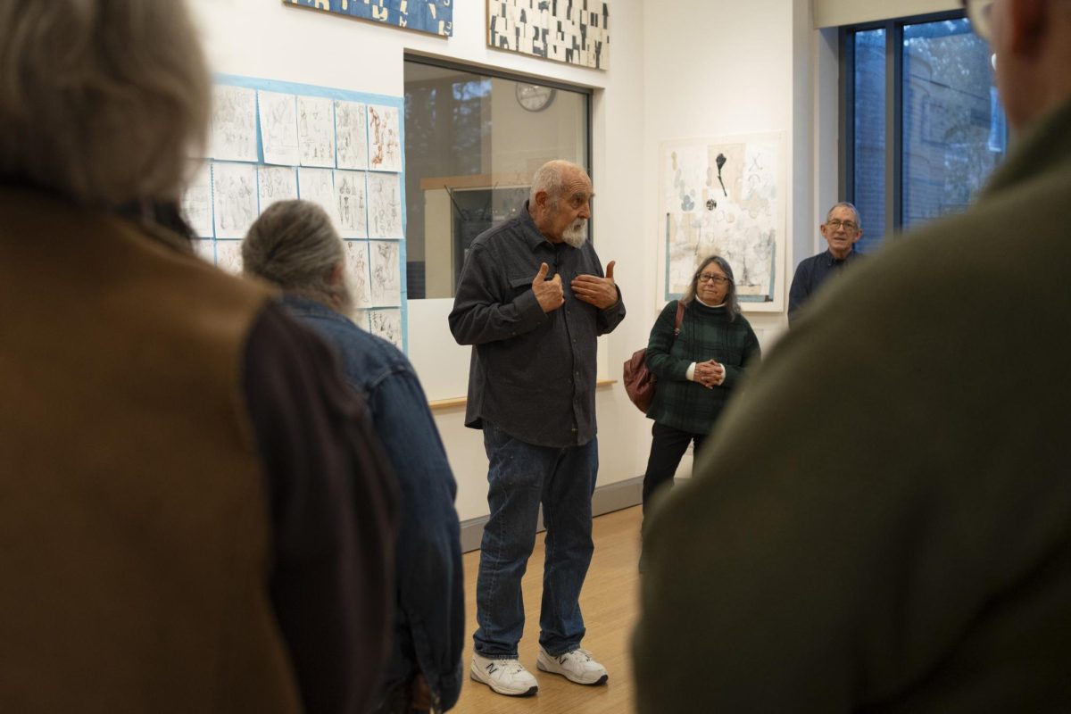 Alan Azhderian addresses attendees at the closing reception and artist talk for his "Context/Content" exhibition on Dec. 4 at the Robert F. Agrella Gallery.