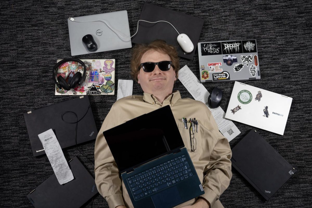 Benjamin Lyle rests in a graveyard of defunct laptops. He hopes this guide will help prevent other students' used laptop purchase tragedies.