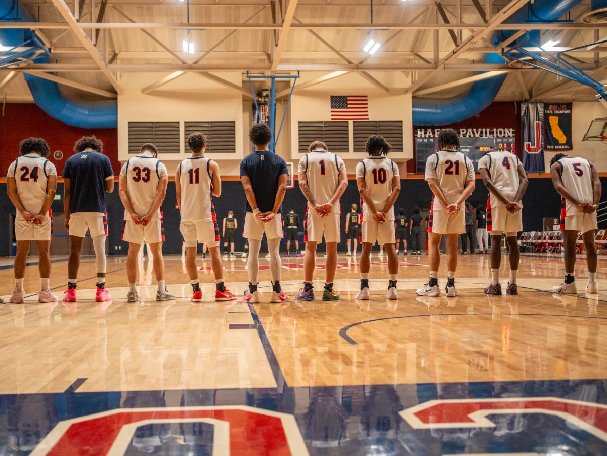 The SRJC men's basketball team stands at the baseline for the national anthem ahead of their game against Napa Valley College on Tuesday, Nov. 11 at Haehl Pavilion.
