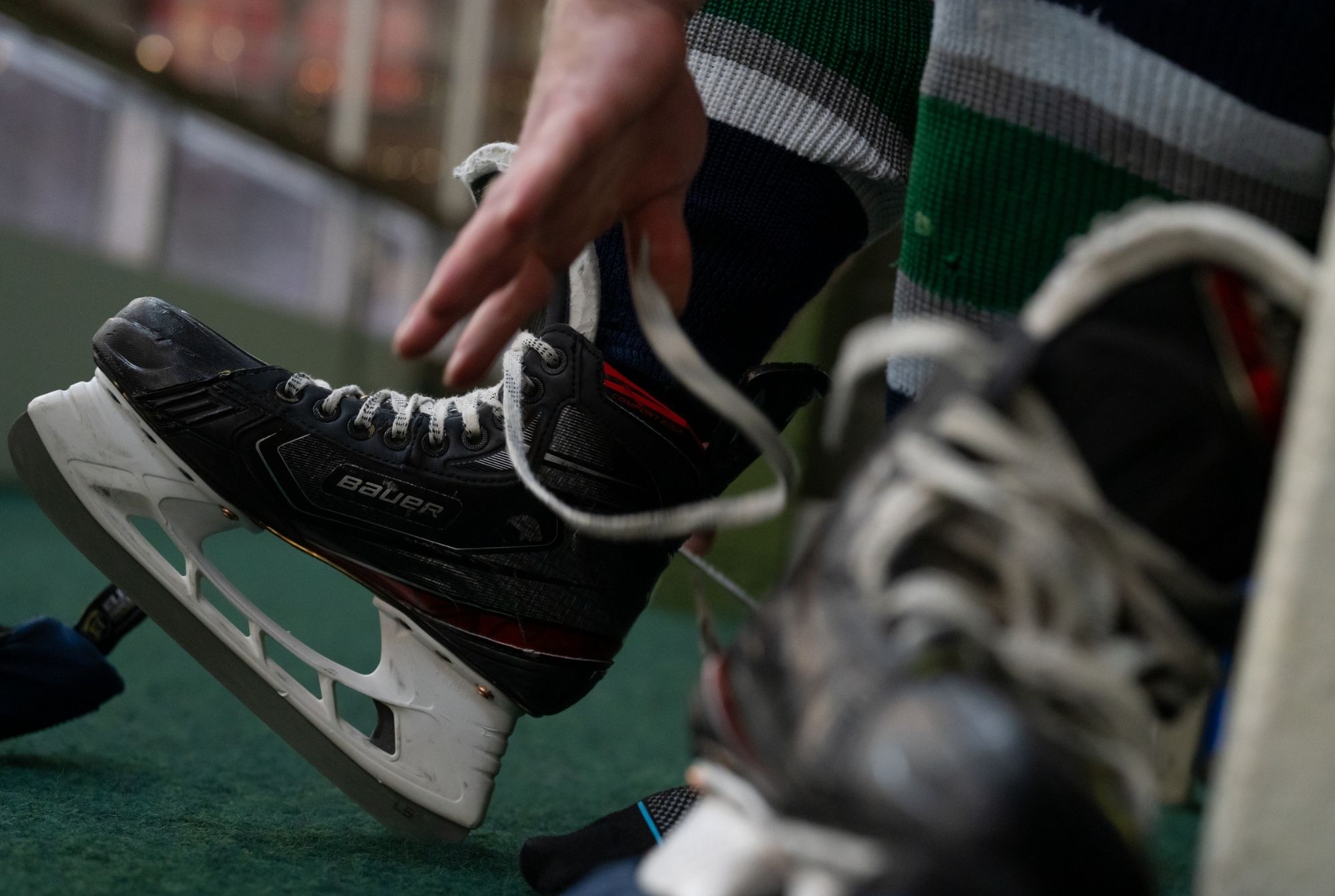 Polar Bears center and winger Traber Burns laces up his skates before practice on Nov. 16, 2025 at Snoopy's Home Ice.
