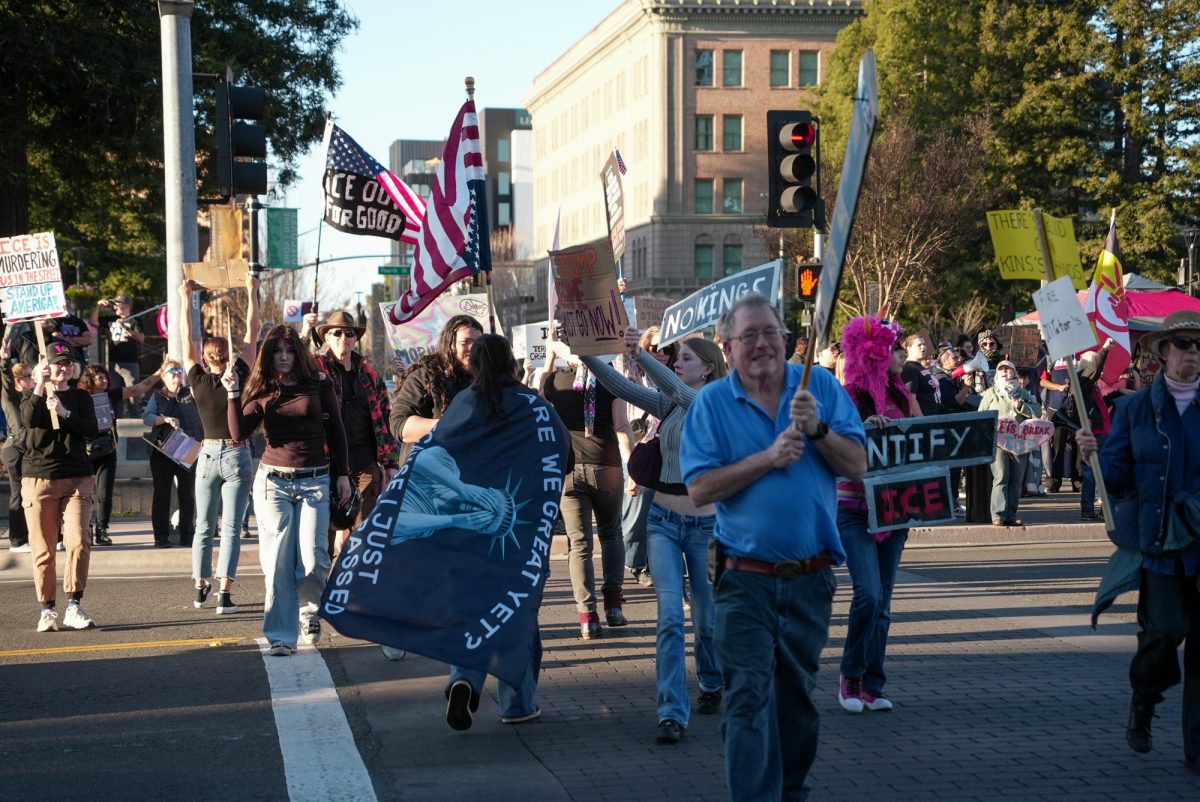 Demonstrators cross to the other side of Third Street during an emergency protest of ICE after the killing of Alex Pretti at Santa Rosa's Courthouse Square on Jan. 24.