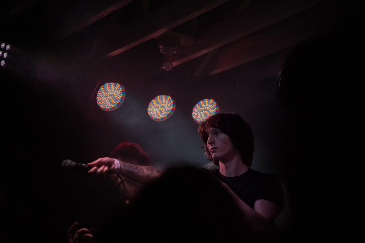 Zane Lynchetti offers the microphone to a crowd of fans who sang each of his songs bar-for-bar back to him during his first performance Dec. 4, 2025 at the DNA Lounge in San Francisco.