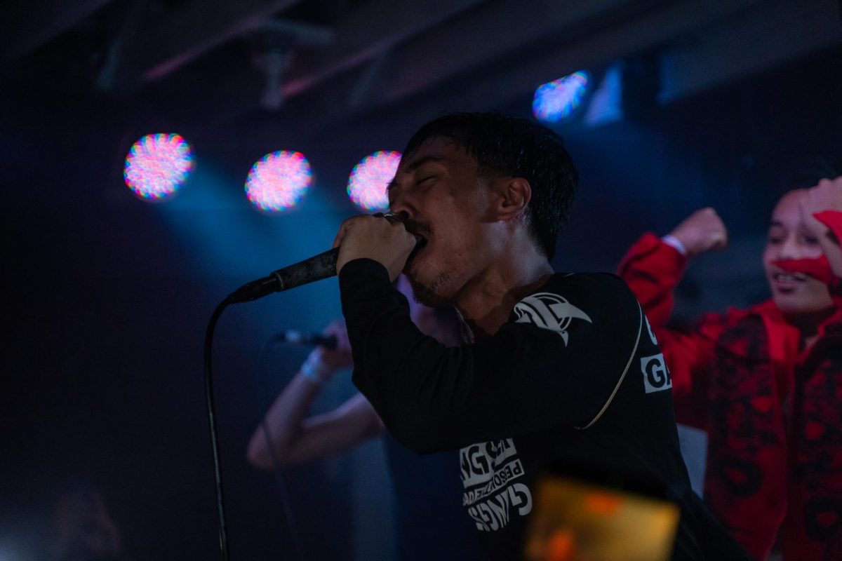 nastynovocaine (aka Jordan Narra, left) sings his heart out while his younger brother (Christian, right) cheers him on Dec. 4, 2025 at the DNA Lounge in San Francisco.