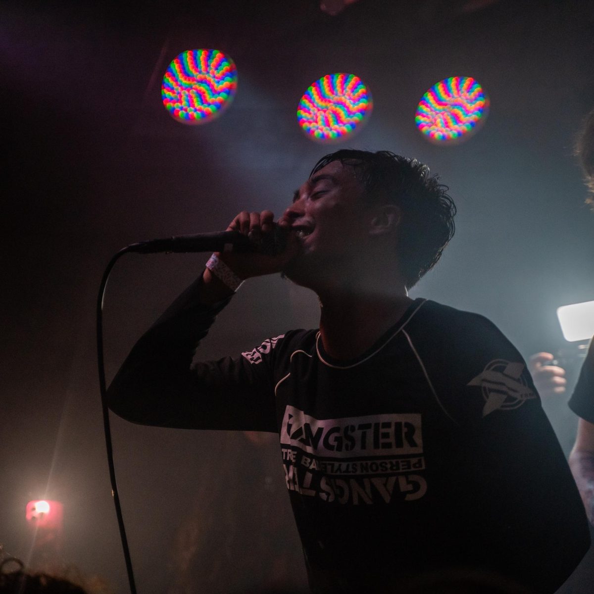 nastynovocaine (aka Jordan Narra) can't help but smile as the light hits him during his first performance in front of a crowd Dec. 4, 2025 at the DNA Lounge in San Francisco.