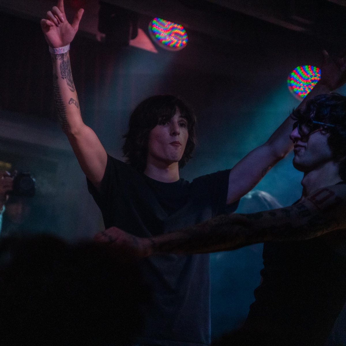 myspacemark's (right) friend and collaborator Zane Lynchetti (left) cheers the headliner on during their first show Dec. 4, 2025 at the DNA Lounge in San Francisco.
